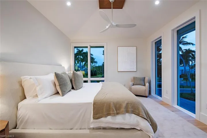 Bedroom featuring recessed lighting, lofted ceiling, access to exterior, and light wood-type flooring