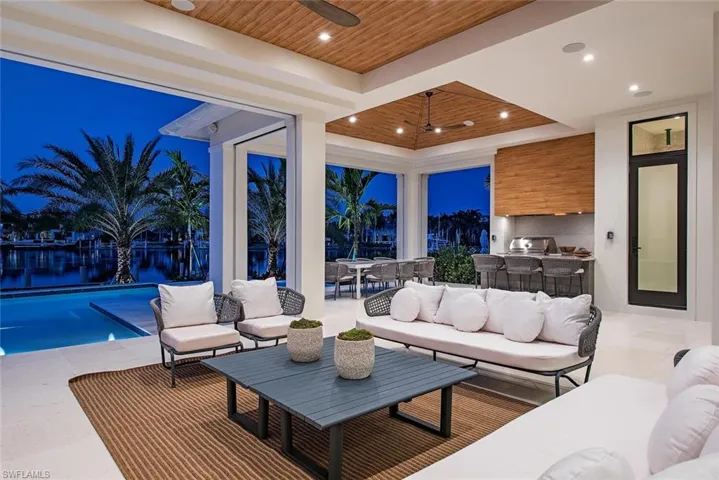View of patio featuring an outdoor hangout area, an outdoor kitchen, outdoor dining area, and ceiling fan