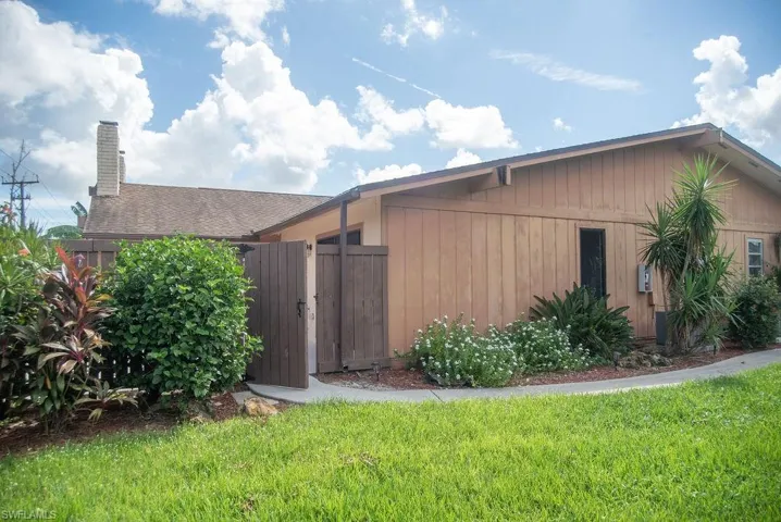 View of side of home with a yard