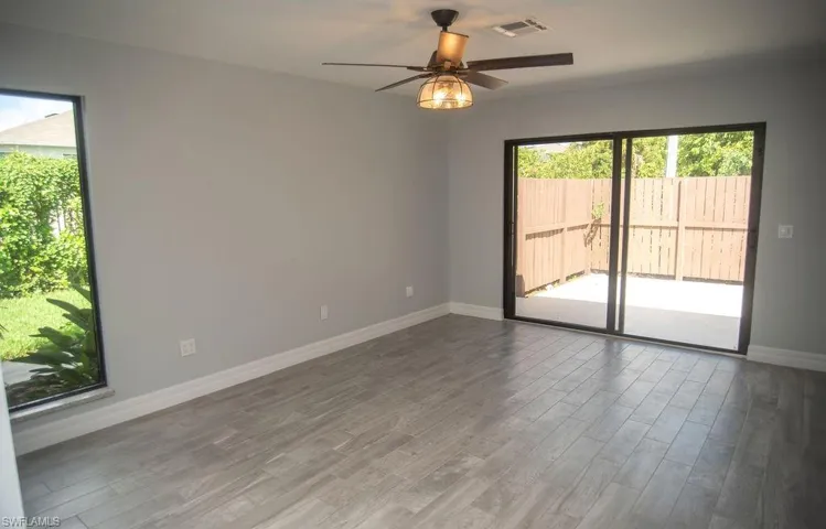 Spare room with hardwood / wood-style flooring and ceiling fan