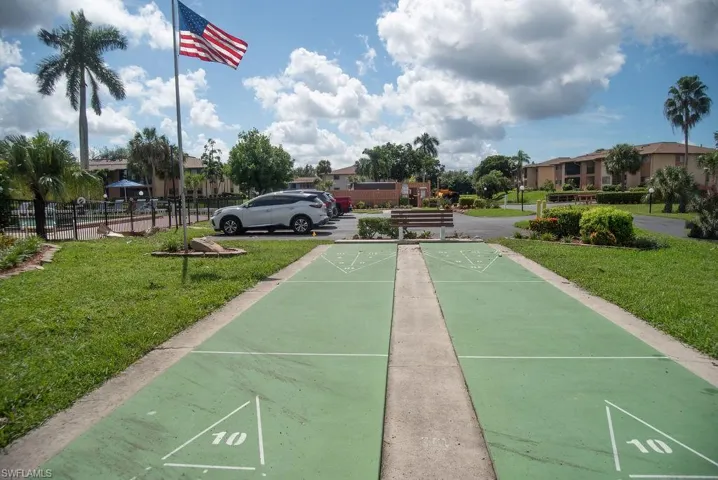 View of home's community with a lawn