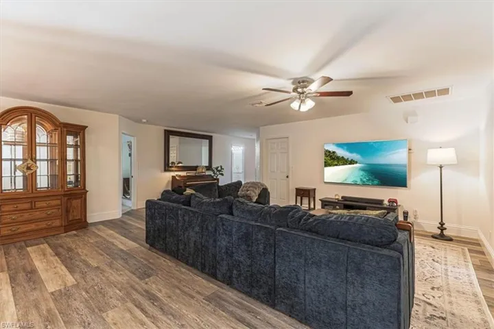 Living area with wood finished floors and a ceiling fan