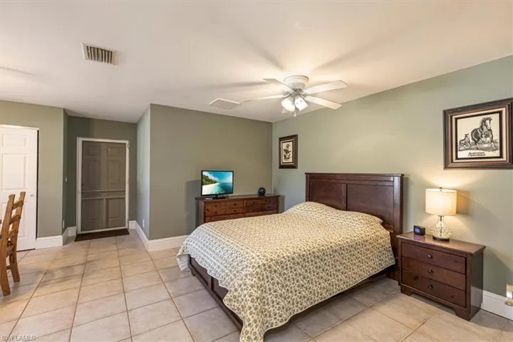 Bedroom featuring light tile patterned flooring and ceiling fan