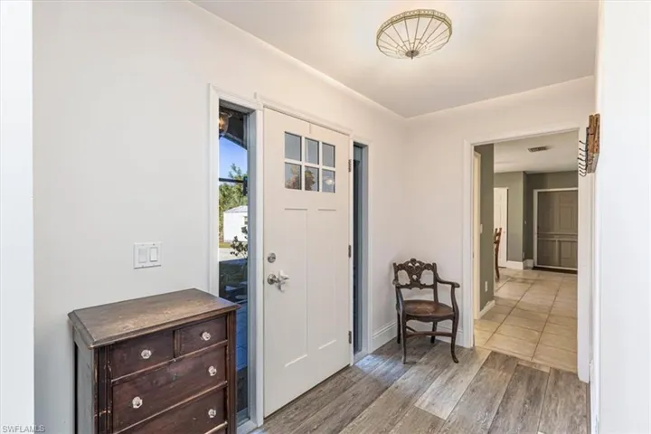 Entryway with light wood-type flooring and baseboards