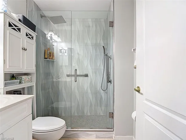 Full bath with vanity and a stall shower