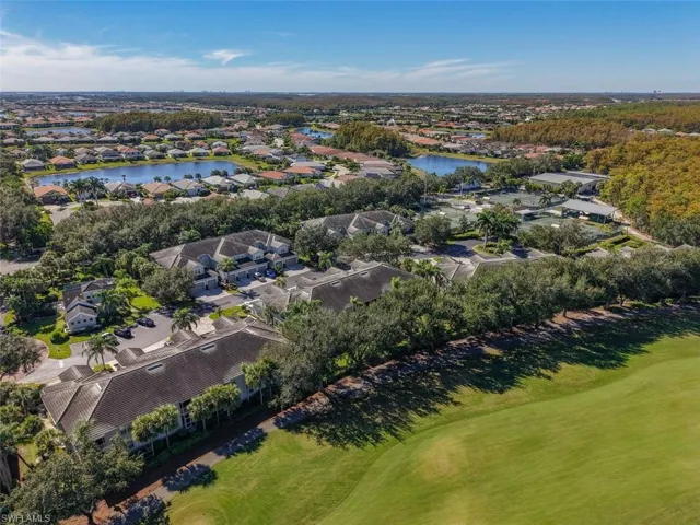 Aerial view of property and surrounding area with nearby suburban area