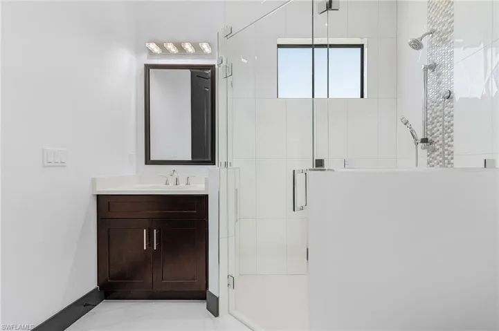 Bathroom featuring vanity and an enclosed shower