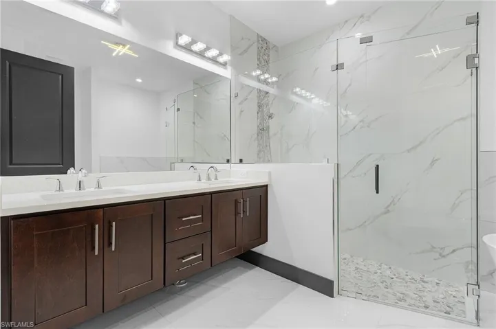 Bathroom with vanity and a shower with shower door