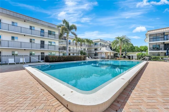 Community pool with a patio