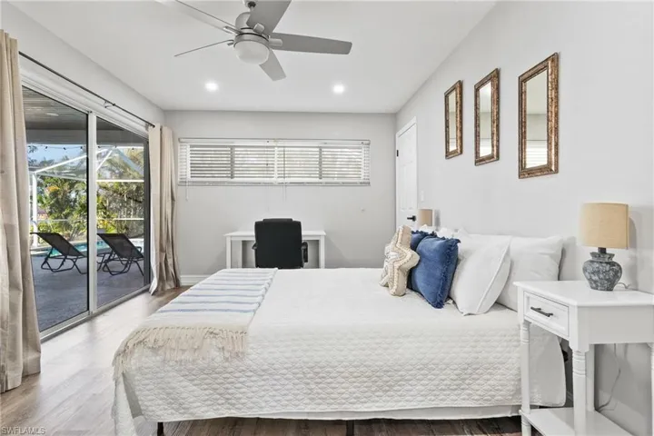Bedroom with access to exterior, wood finished floors, baseboards, ceiling fan, and recessed lighting