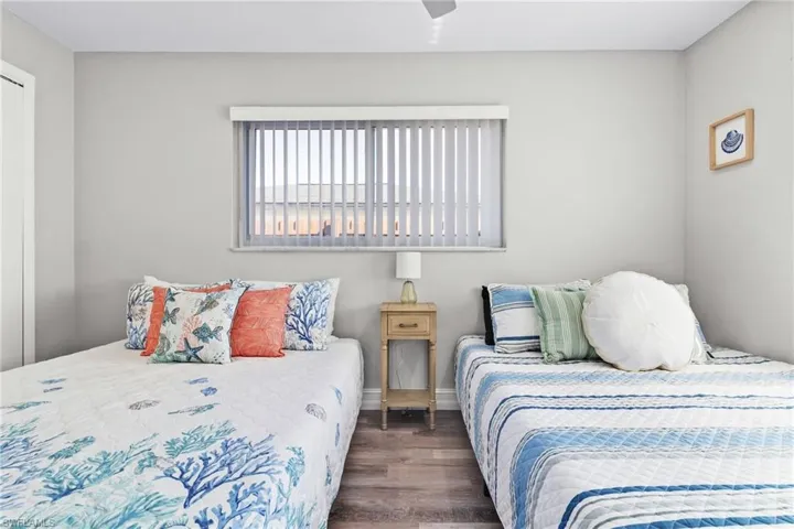 Bedroom with baseboards, ceiling fan, and wood finished floors