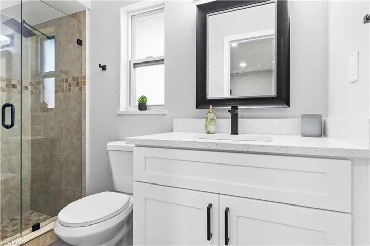 Bathroom featuring toilet and a shower stall