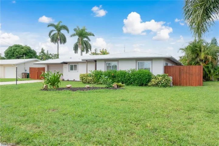 Ranch-style home with a garage and a front yard