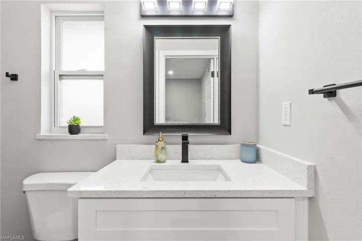 Half bath featuring toilet and vanity