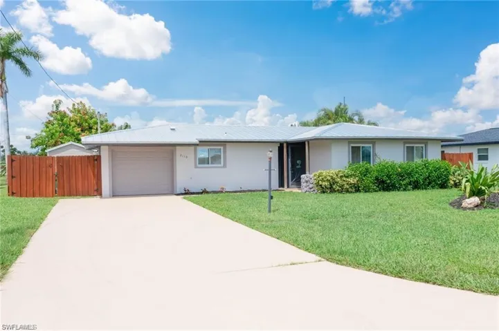 Ranch-style home with a garage and a front yard