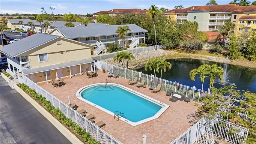 Community pool featuring a patio and a water view