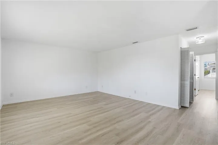 Spare room featuring light wood-type flooring and baseboards