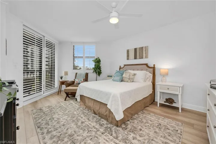 Spacious Guest Bedroom featuring Ceiling Fan, Light Wood-Style LVP Flooring