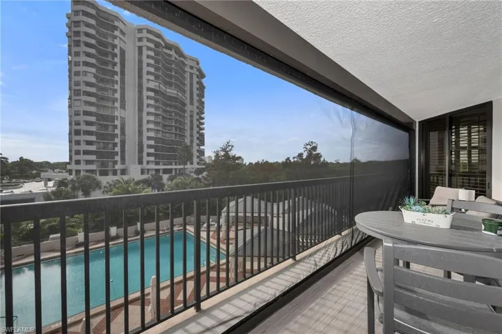 Balcony featuring Storm Smart Hurricane Screens with View of Pool Area