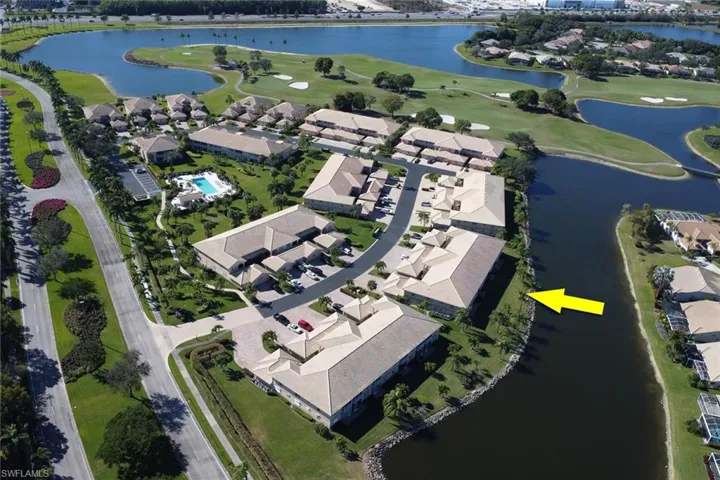 Aerial view of property and surrounding area featuring nearby suburban area