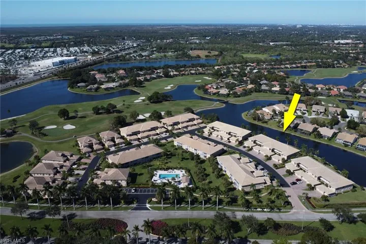 Aerial view of property's location with a large body of water, nearby suburban area, and a golf course