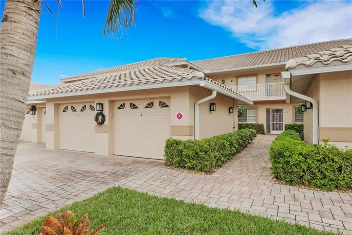 Mediterranean / spanish home featuring stucco siding, a tile roof, a garage, and decorative driveway