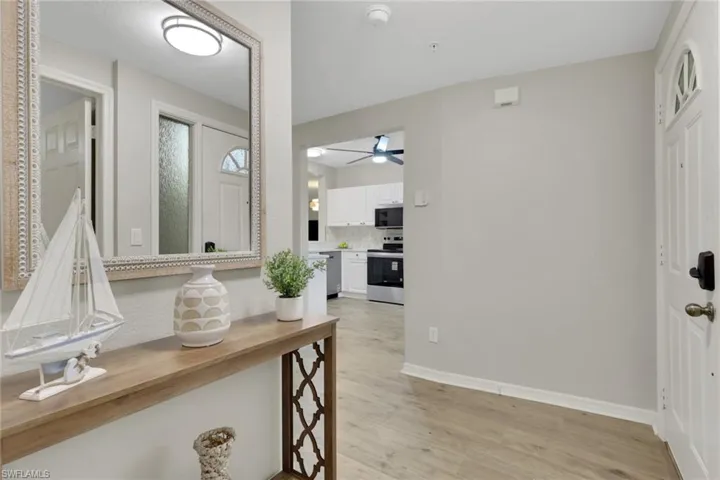 Entrance foyer with light wood-type flooring and baseboards