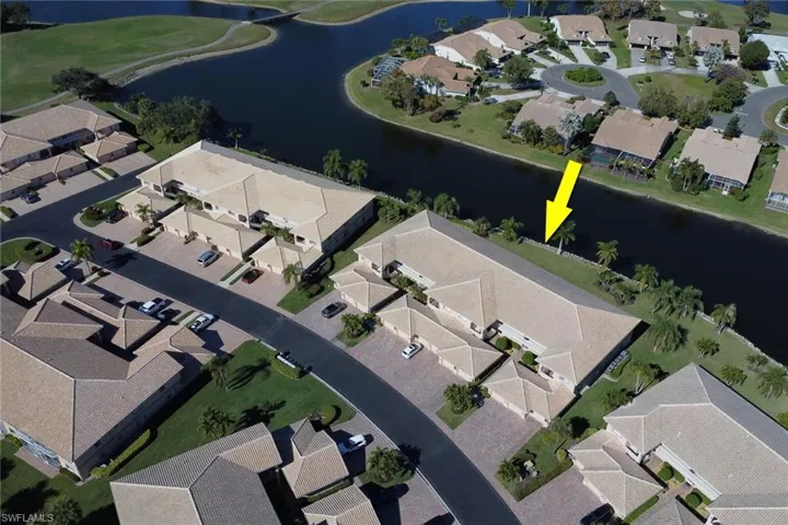 Aerial overview of property's location with a large body of water and nearby suburban area
