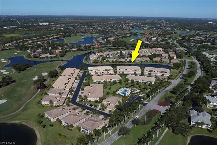Aerial overview of property's location with a nearby body of water, nearby suburban area, and a local golf course
