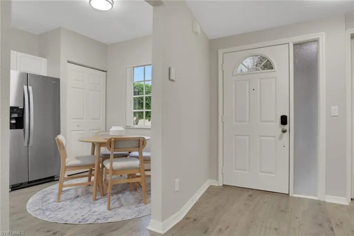 Foyer entrance with light wood-type flooring
