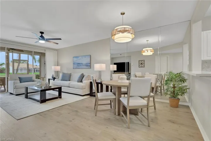 Living room with ceiling fan and light wood finished floors