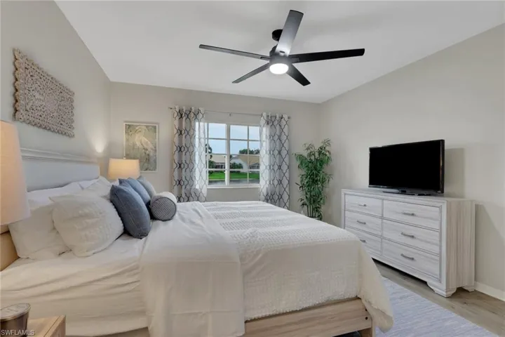 Bedroom with light wood-style floors and ceiling fan
