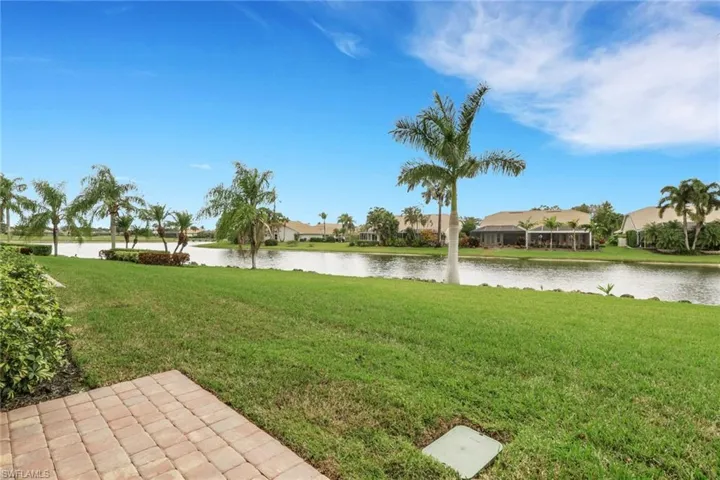 View of green lawn with a water view and a residential view