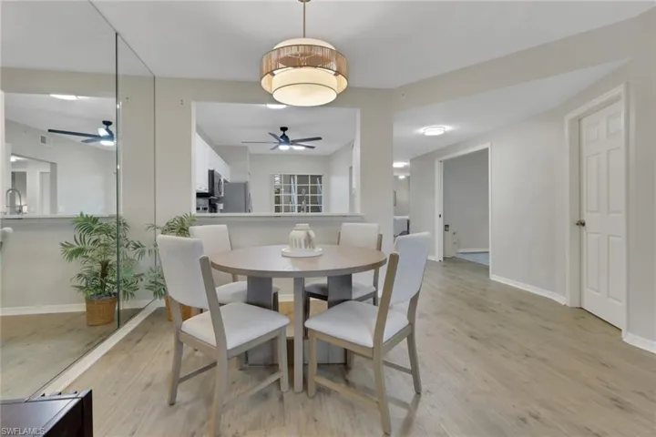 Dining space with light wood-style flooring and ceiling fan