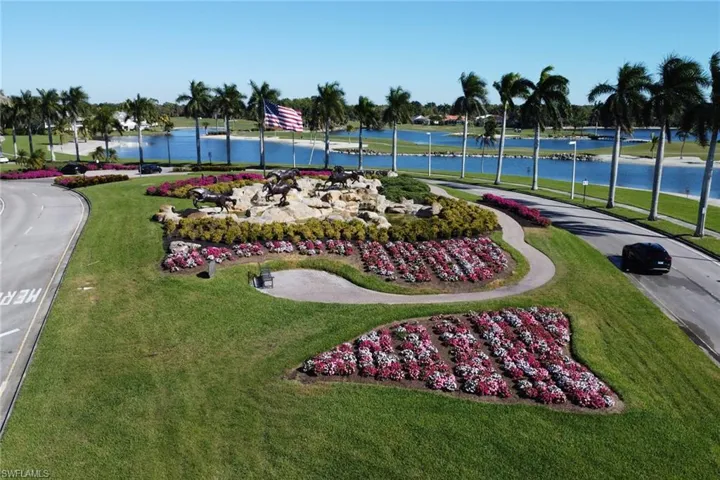 View of property's community with a water view and a yard