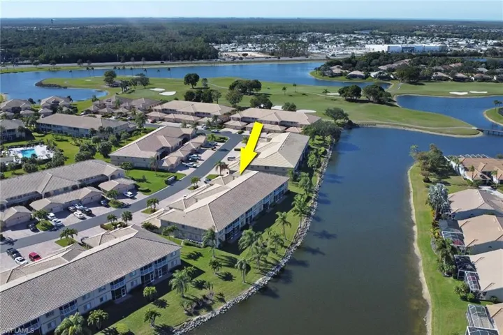 Aerial perspective of suburban area with a large body of water and a local golf course