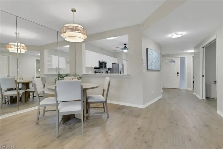 Dining area featuring light wood-type flooring and ceiling fan