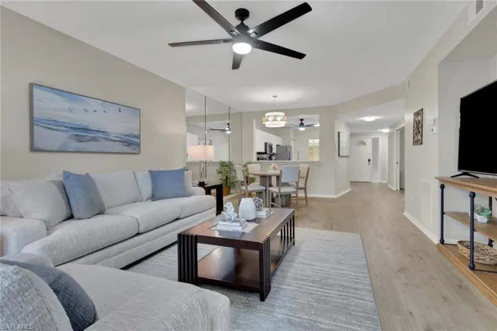 Living area with ceiling fan and wood finished floors