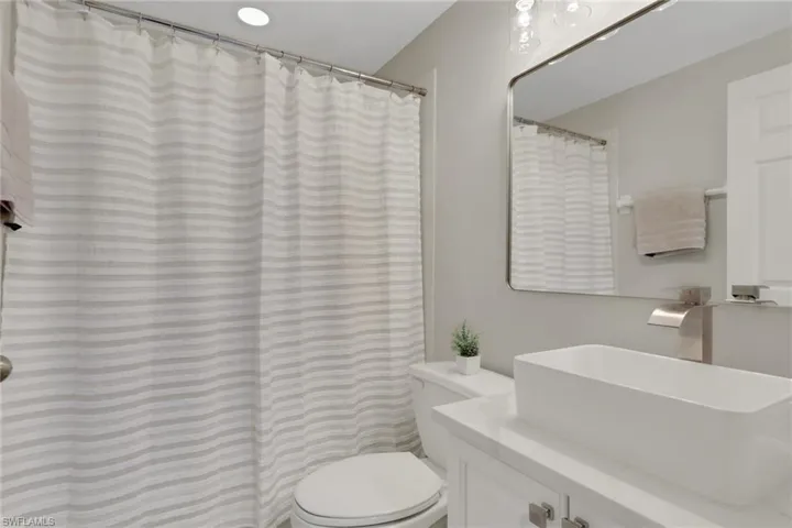 Bathroom with vanity and a shower with shower curtain