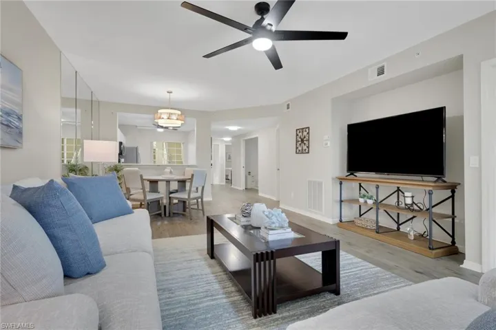 Living room with a ceiling fan and wood finished floors