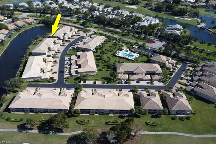 Aerial overview of property's location featuring a nearby body of water and nearby suburban area
