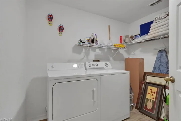 Laundry room featuring light wood finished floors and independent washer and dryer