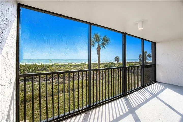 Unfurnished sunroom featuring a water view and a wealth of natural light