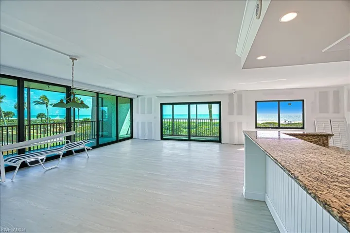Unfurnished living room with light wood-type flooring, floor to ceiling windows, and recessed lighting