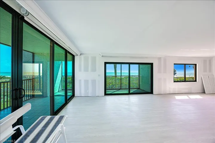 Unfurnished room featuring wood finished floors and plenty of natural light