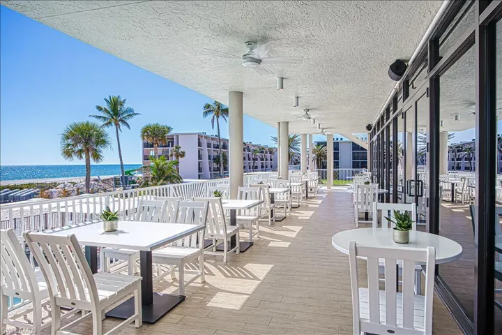 View of patio / terrace featuring a water view, ceiling fan, and outdoor dining area