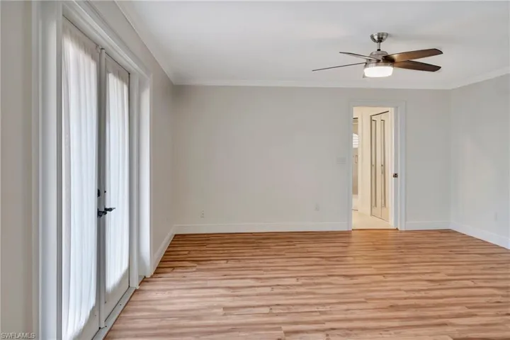 Primary Bedroom with French doors to balcony