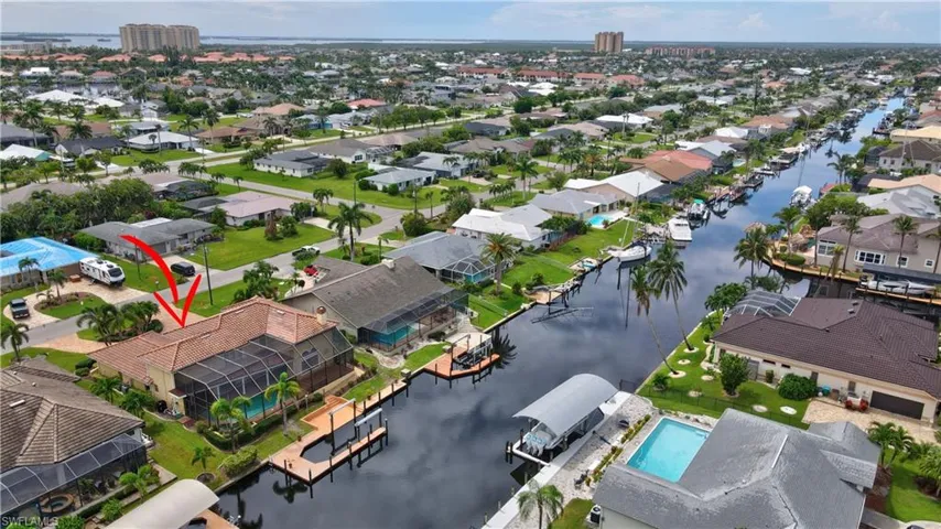 Birds eye view of property with a water view