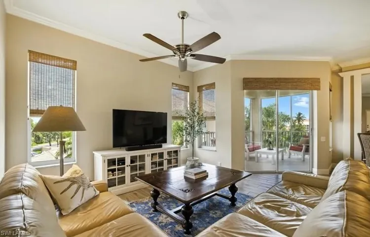 Living room with wood finished floors, ornamental molding, and a ceiling fan