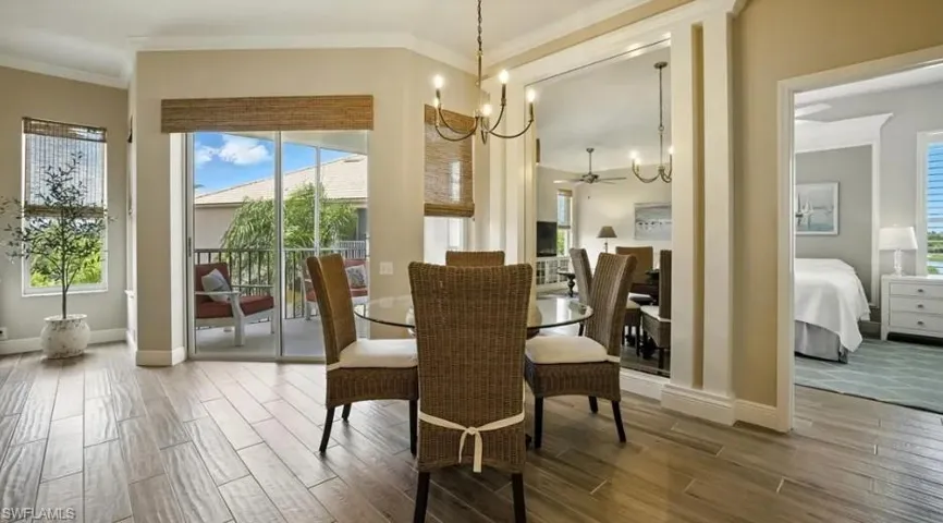 Dining area with a chandelier, wood finish floors, a ceiling fan, and crown molding